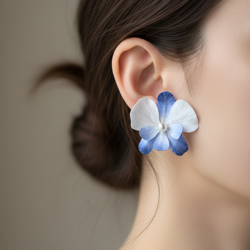 Close-up side view of ear wearing Handmade Blue Orchid Ronghua Flower Earrings